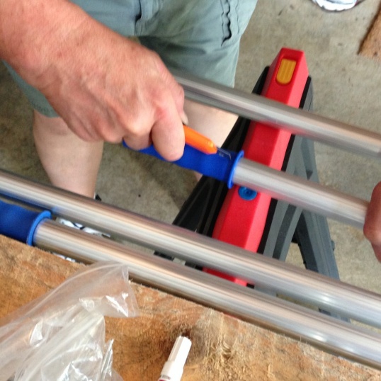 Use a sharp knife to cut through the plastic on the Paint Pole Handle