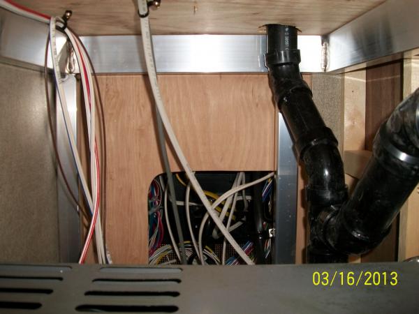 View of the Power Panel rear, as viewed from the pass through storage area.  Looking over top the Furnace.