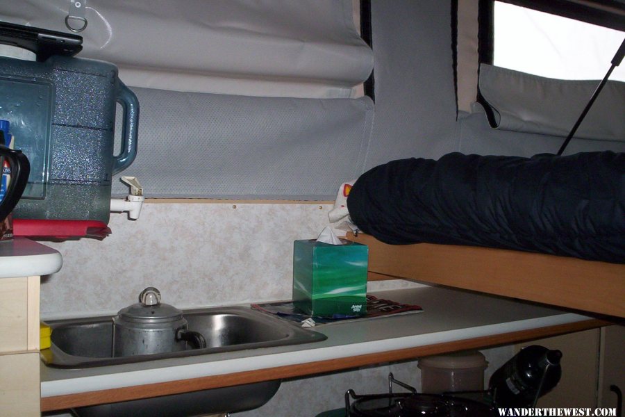 View of water container and sink with bed pulled out