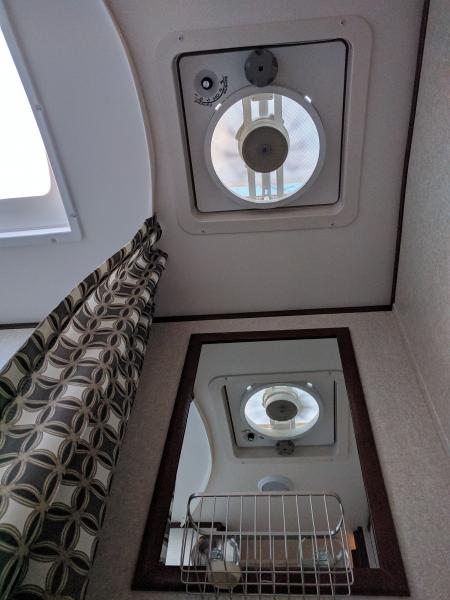 Vortex 2 fan in bathroom. Also visable is brushed nickel basket mounted to bathroom mirror.