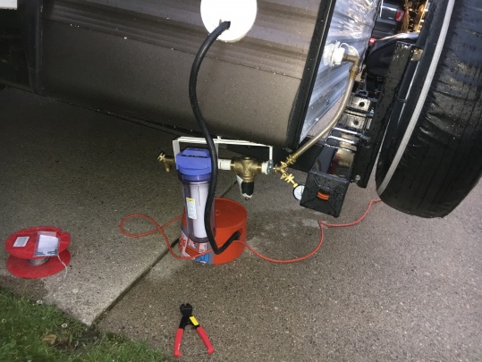 Water filter "installed".  The bracket attaches to a cable under the camper so I can hook it on when I arrive at the campsite.