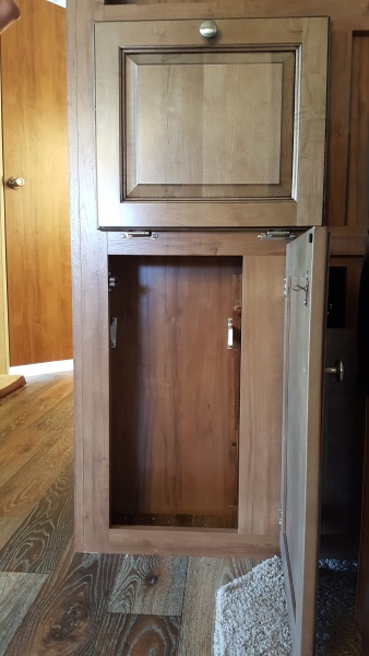 We decided on the lower cabinet space in our entertainment center is a good space for garbage. Installed brackets that plastic grocery bags hang from.