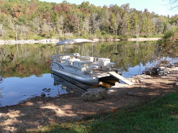 We love our pontoon also! Got a trolling motor on the front to fish around the points. That is a pet-step ramp going from shore to boat. Holds 300 lbs