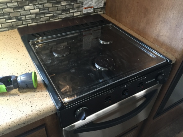 We rarely cook on the stove, so I made a plexiglass cover for the stove.  This cover sits flat (about 1.5" lower than the metal grate) so we can more 