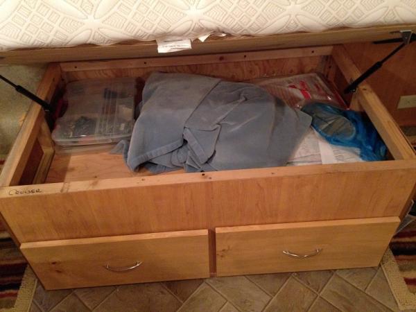 We used 1x10 pine for the drawer fronts and stained them to match.  The drawer pulls are from Lowes and match the rest of the trailer.